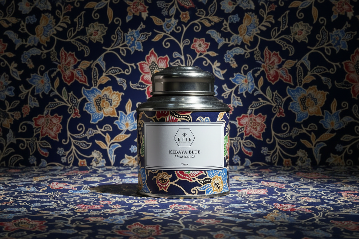 Candle tin with floral design against a patterned fabric background