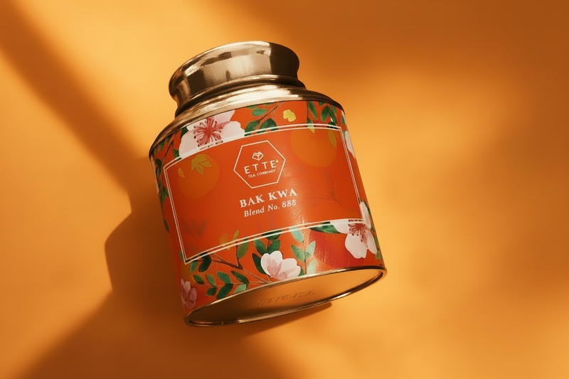 Candle tin labeled 'BAK KWA' with floral design on a yellow background