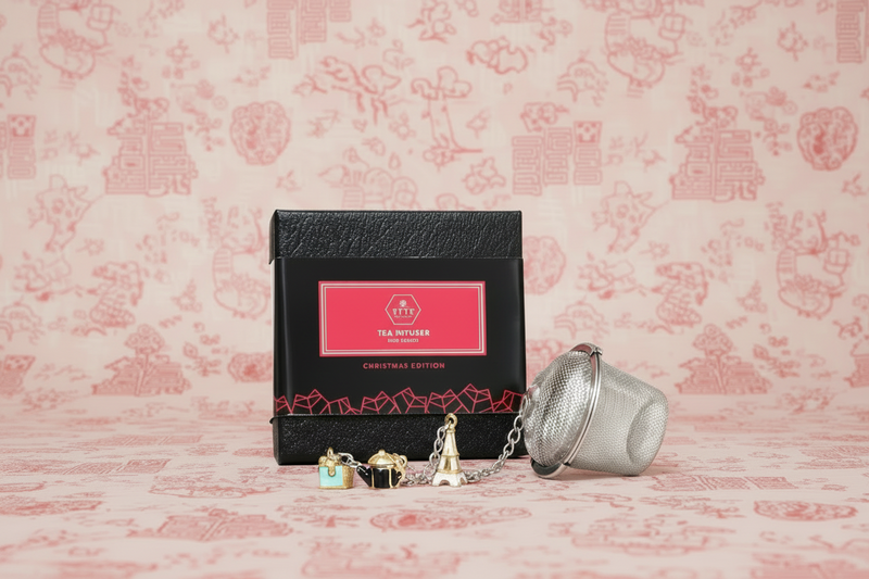 Tea infuser and packaging on a pink floral background