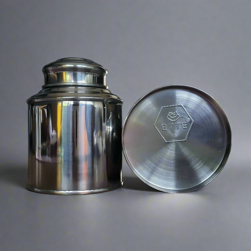 2 Customisable tea tins. With ETTE TEA logo showing at the bottom of one of the tin lying down.