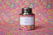 Tea canister with colorful label on a wooden surface