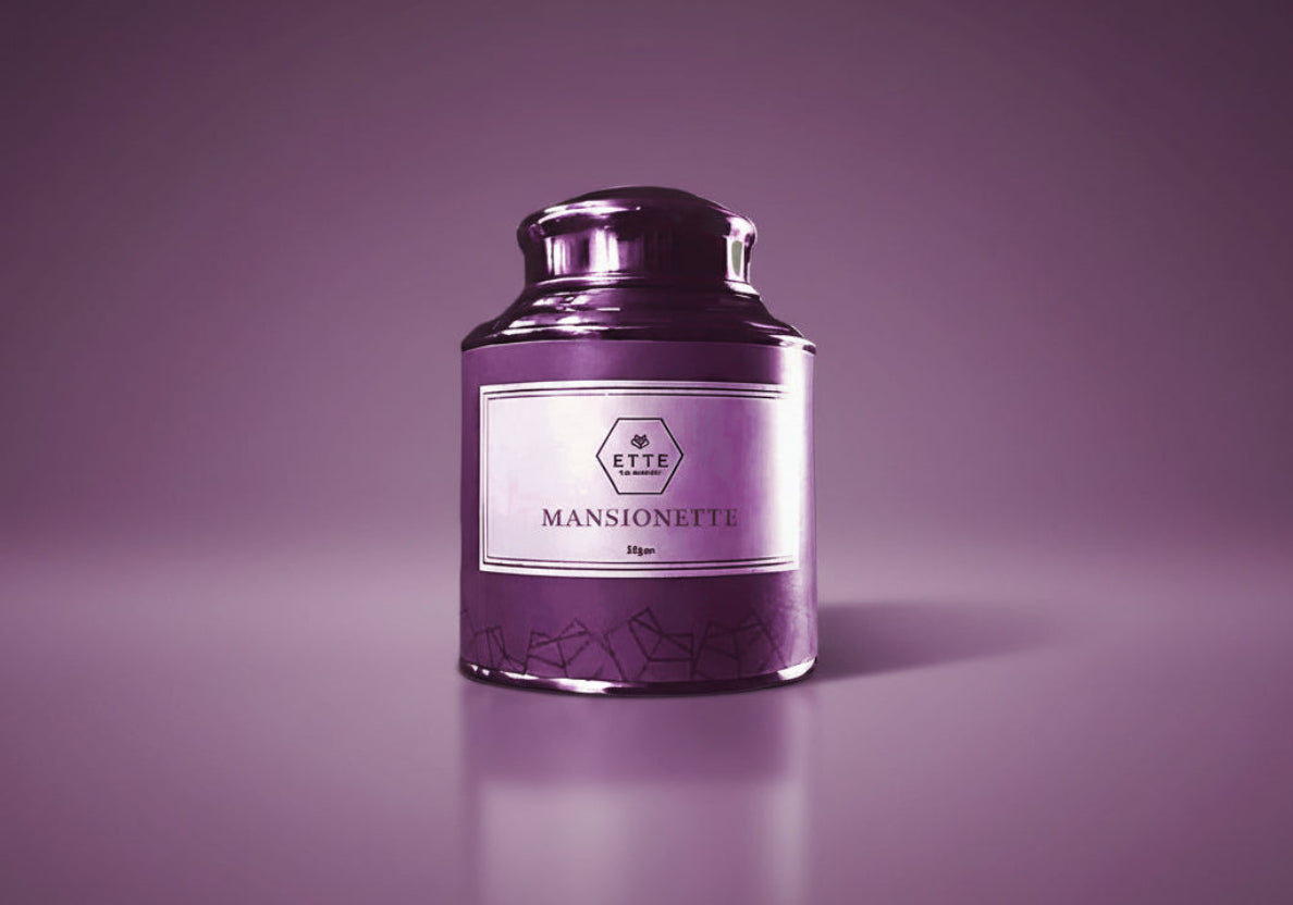 Purple candle with a label "MANSIONETTE" on a white background
