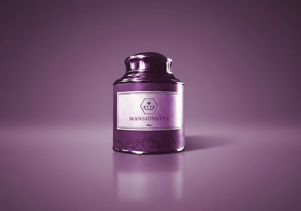 Purple candle with a label "MANSIONETTE" on a white background