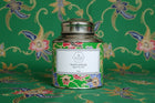 Decorative tea canister with floral design on a matching patterned background