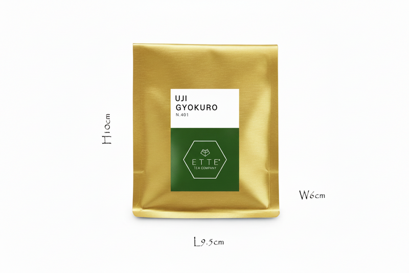 Gold tea bag with a label on a white background