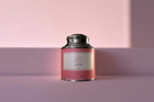 Pink tea canister with silver lid on a pink background