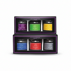 Set of tea tins in a decorative box with colorful labels on a white background
