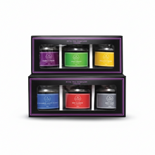 Set of tea tins in a decorative box with colorful labels on a white background