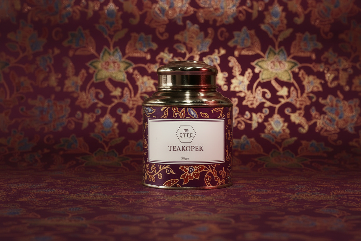 Tea canister with decorative label on a patterned fabric background