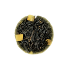 Close-up of black tea leaves with a yellowish background
