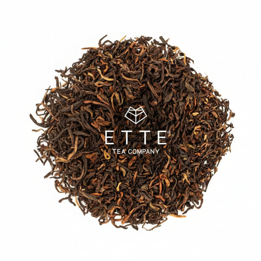 Dry black tea leaves with 'ETTE Tea Company' logo on a white background